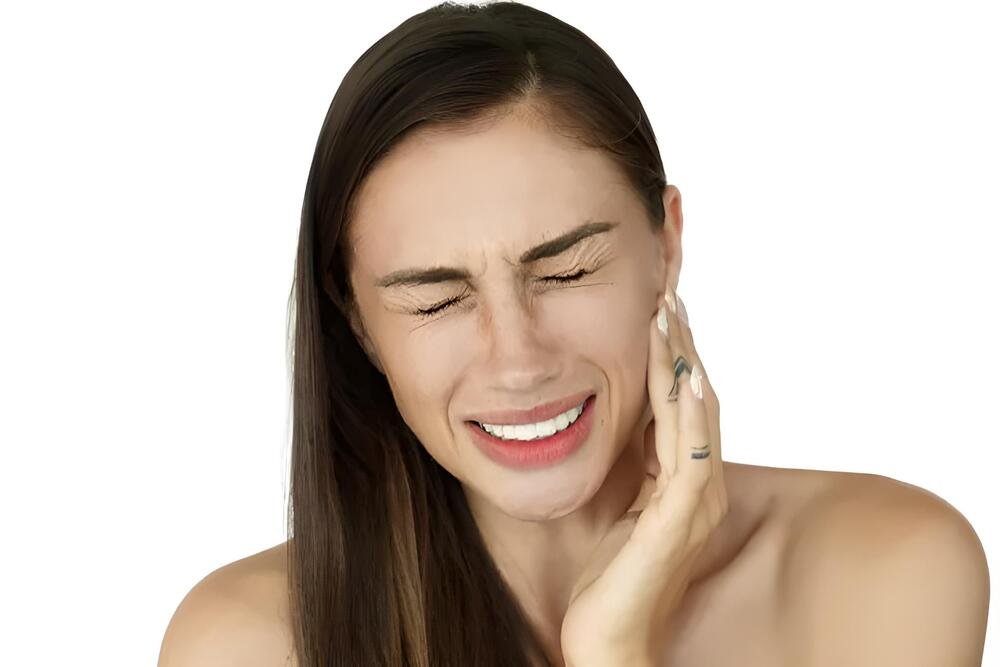 mujer tocando su mandibula con dolor por bruxismo